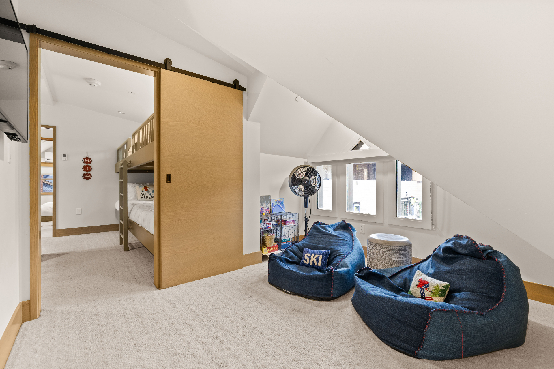 Kids play area and bunk room with barn door